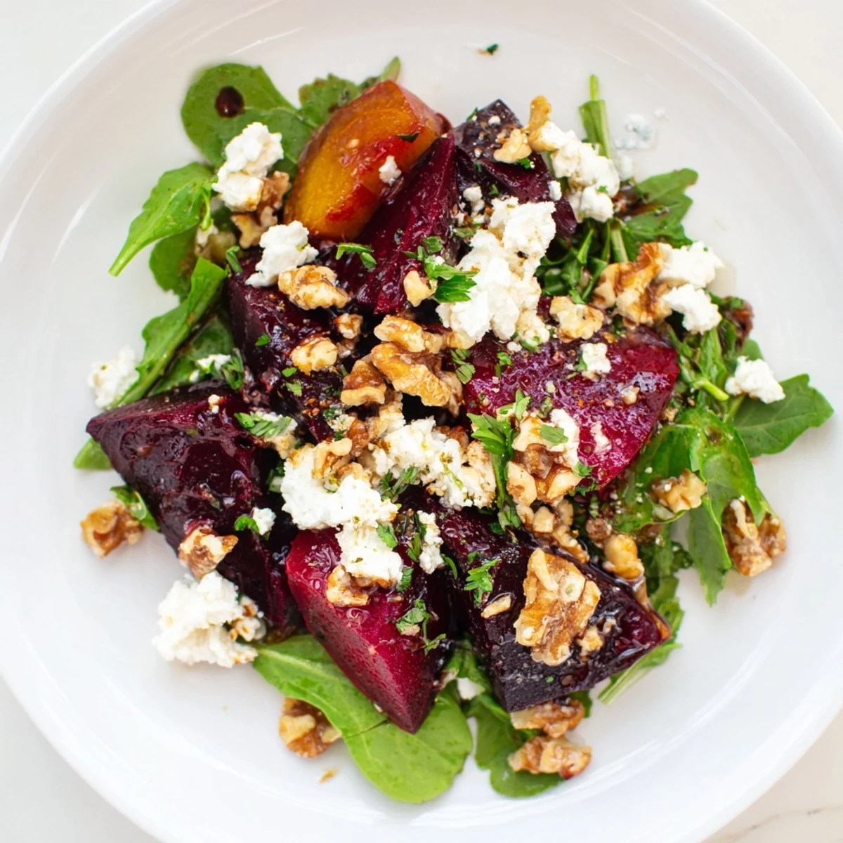 Vibrant Roasted Beet and Goat Cheese Salad, drizzled with tangy balsamic vinaigrette, ready to serve.