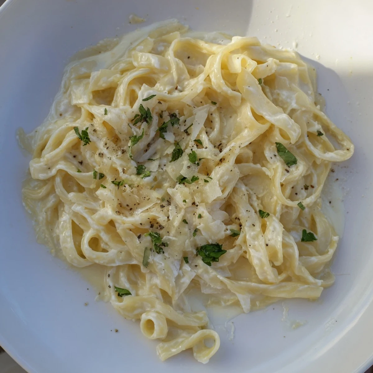 Enjoy a forkful of this delicious creamy garlic Parmesan pasta, a comforting Italian vegetarian dish.