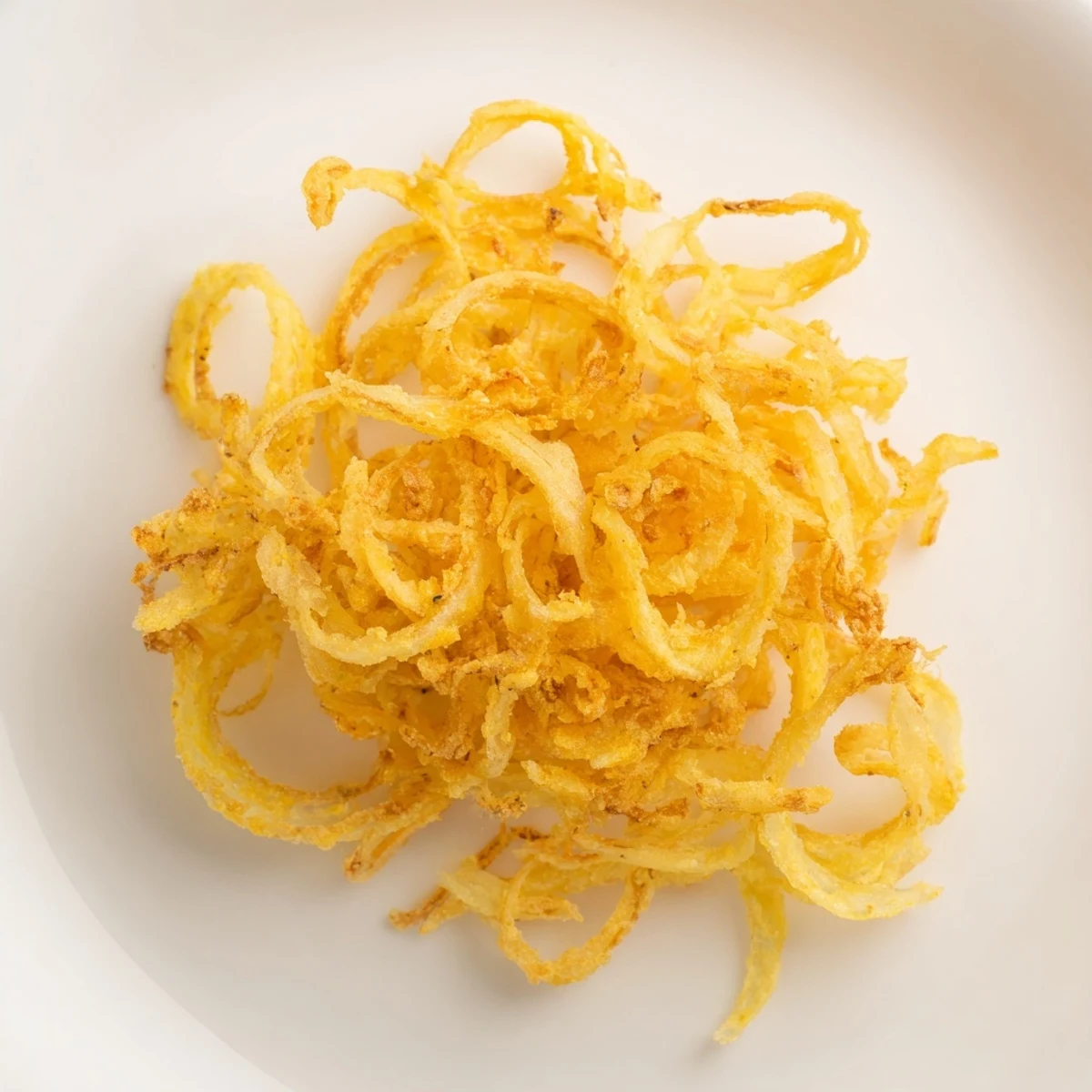 Freshly made crispy fried onions, perfectly golden and awaiting their delicious garnish role.