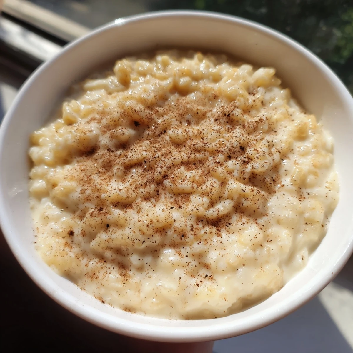 Delicious, homemade rice pudding with cinnamon, a comforting, gluten-free treat for all.