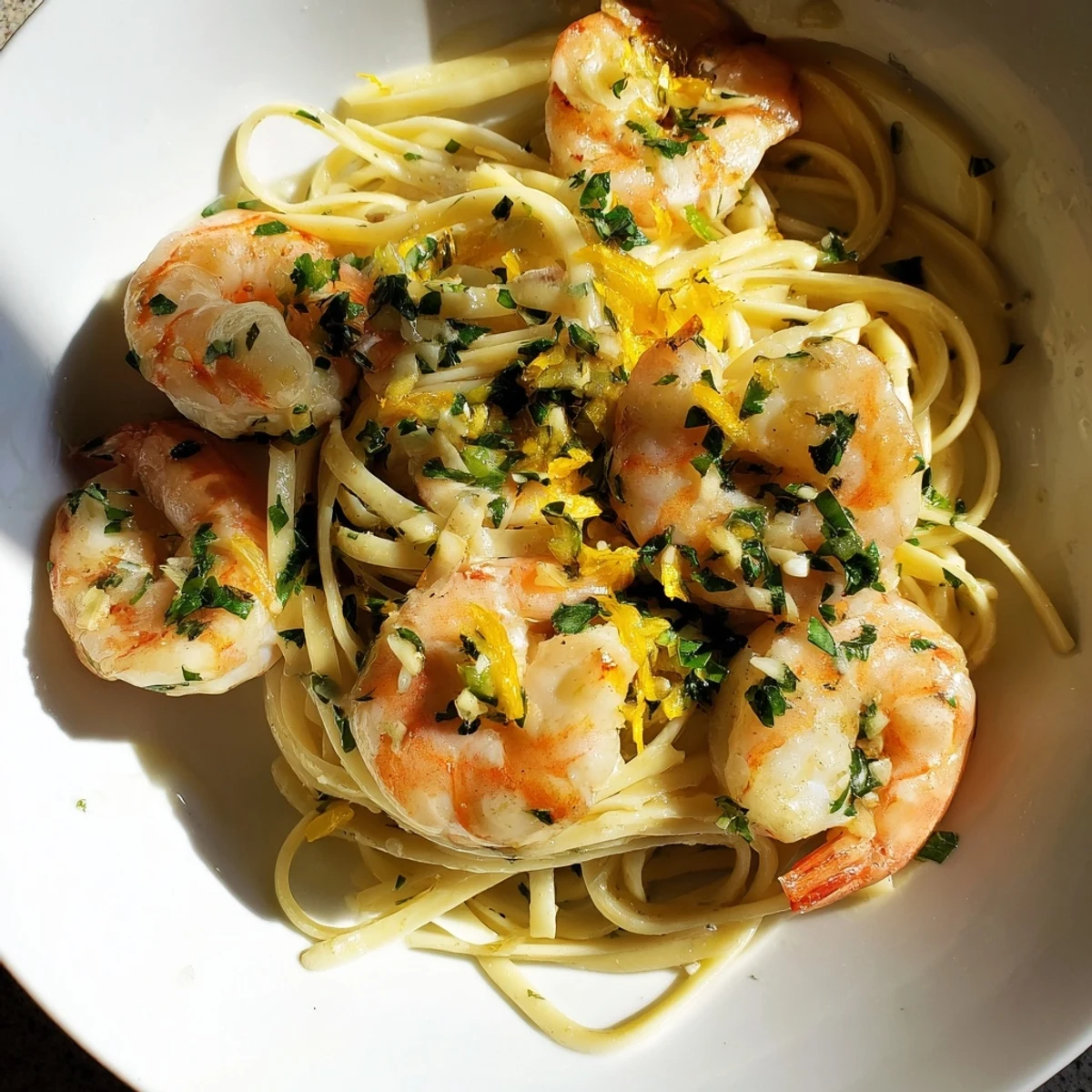 Lemon Garlic Shrimp Scampi: Golden shrimp in a buttery sauce with pasta and fresh parsley, a delicious meal.