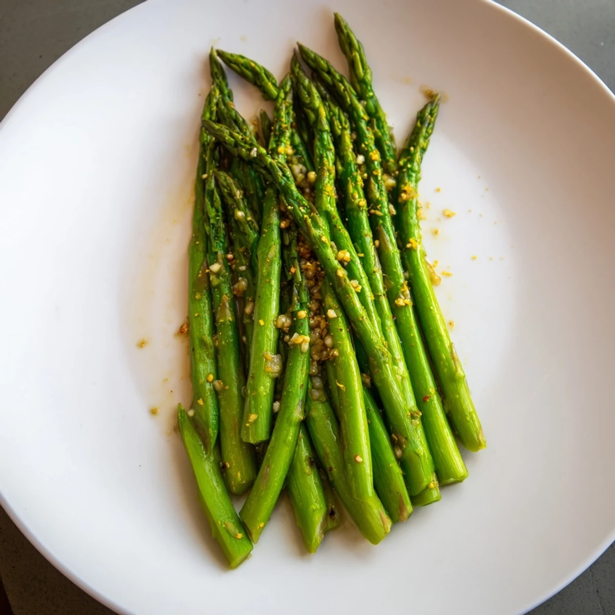 Golden-brown garlic asparagus, seasoned with pepper, ready to serve and enjoy as a fantastic side.