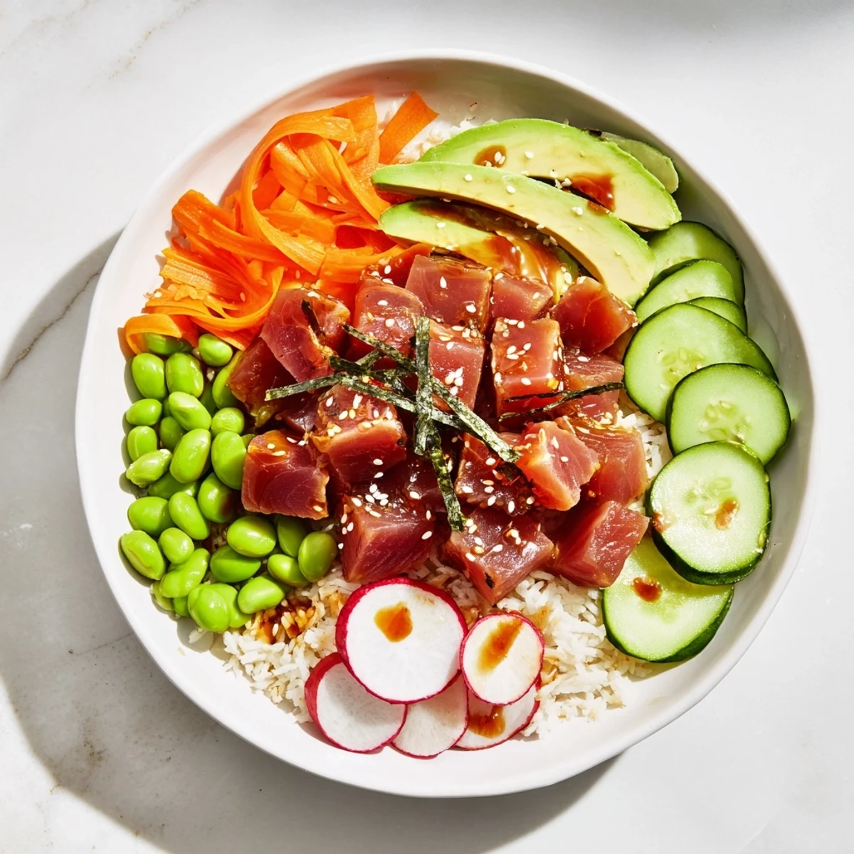 This healthy tuna bowl features tender tuna chunks atop fluffy rice and avocado for lunch.