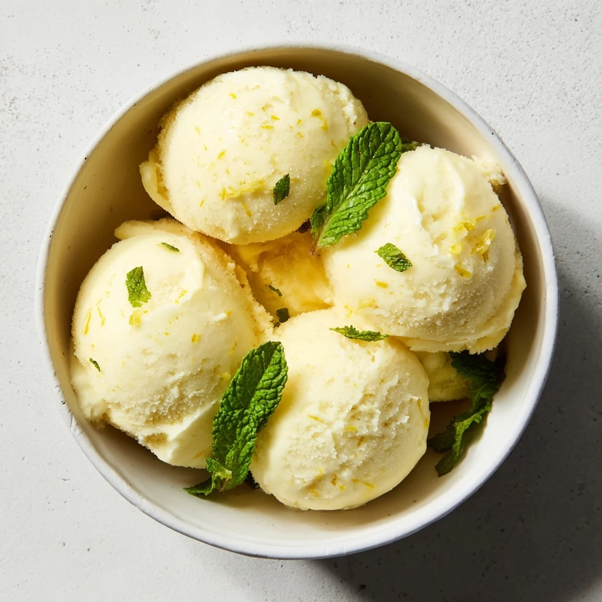 Homemade lemon sorbet, smooth and icy, served in elegant glass bowls after dinner.