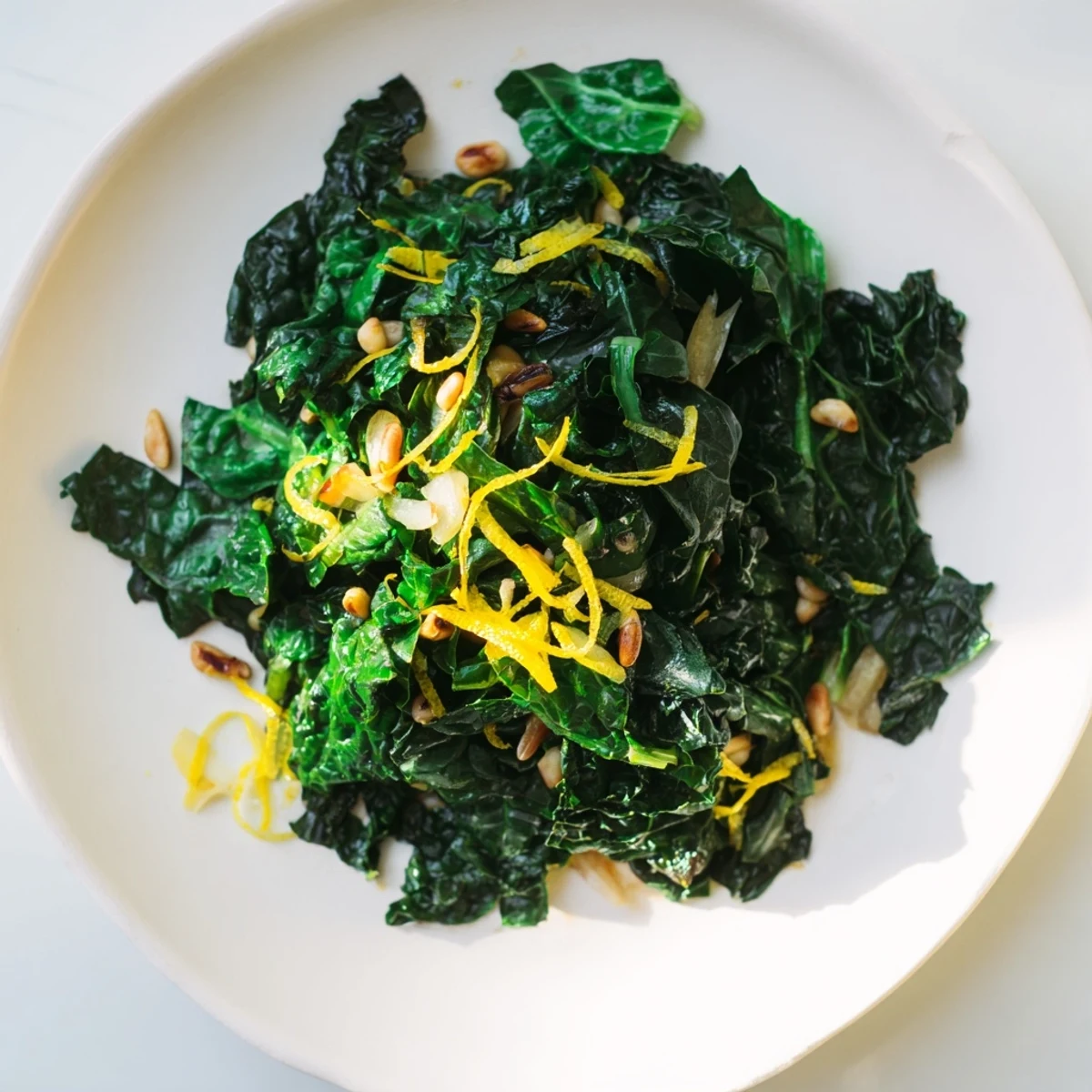 Sautéed Winter Greens with garlic and lemon, a vibrant, bright green side dish ready to be served.