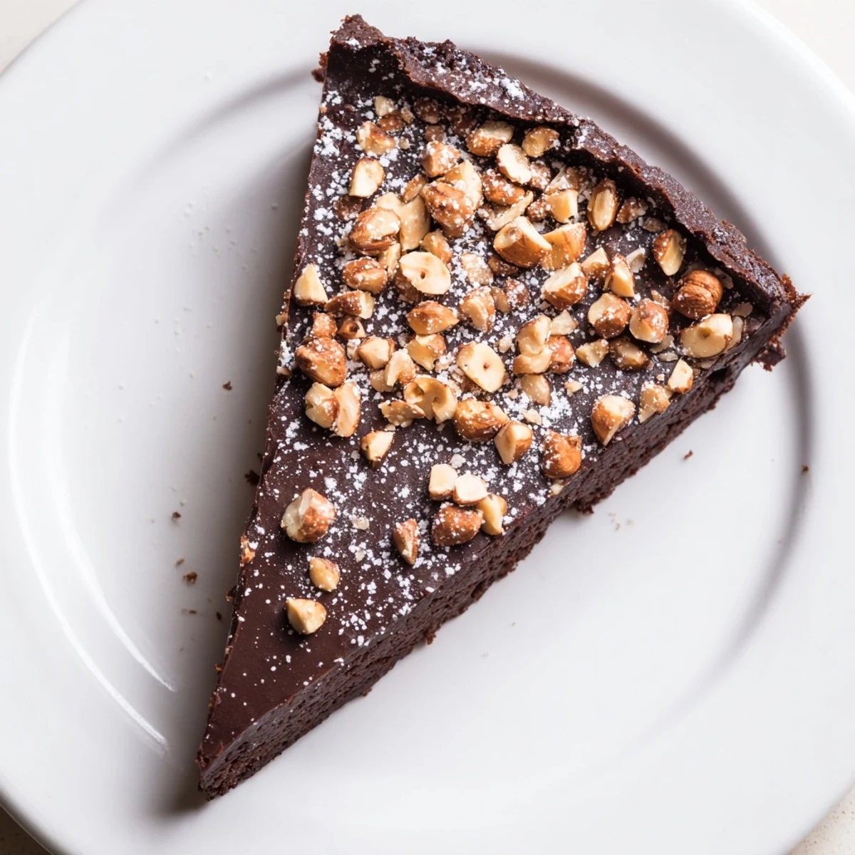 A slice of rich Chocolate and Hazelnut Torte, dusted with powdered sugar and invitingly moist.