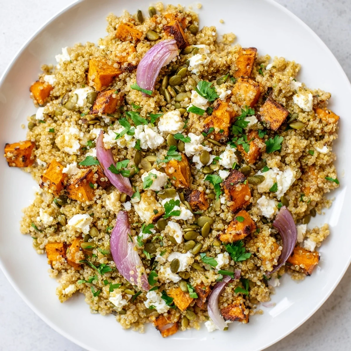 Enjoy fluffy quinoa and caramelized vegetables in this colorful warm quinoa salad creation.