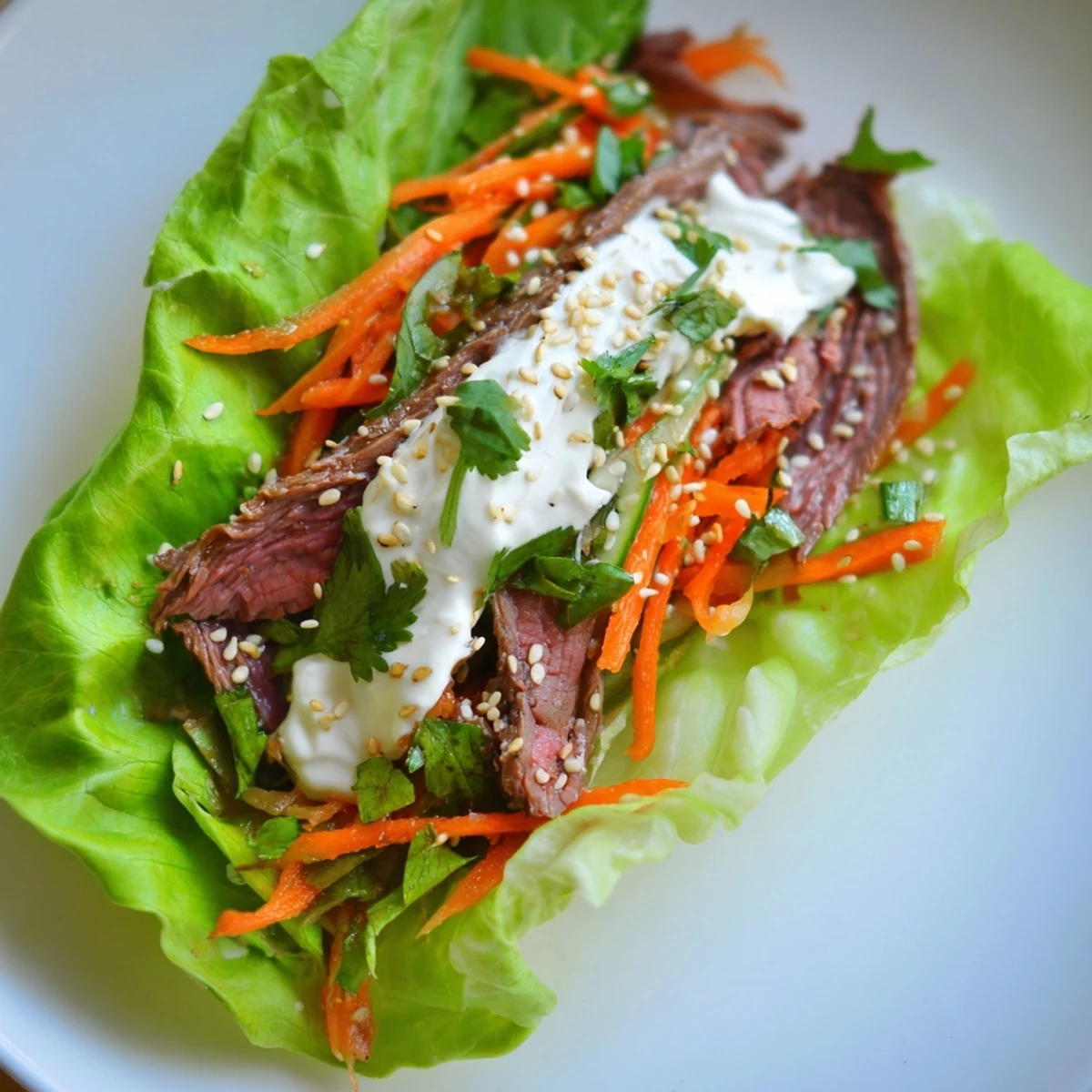 Beef Wrap with Lettuce served with sesame seeds and julienned carrots for a quick, protein-packed lunch.