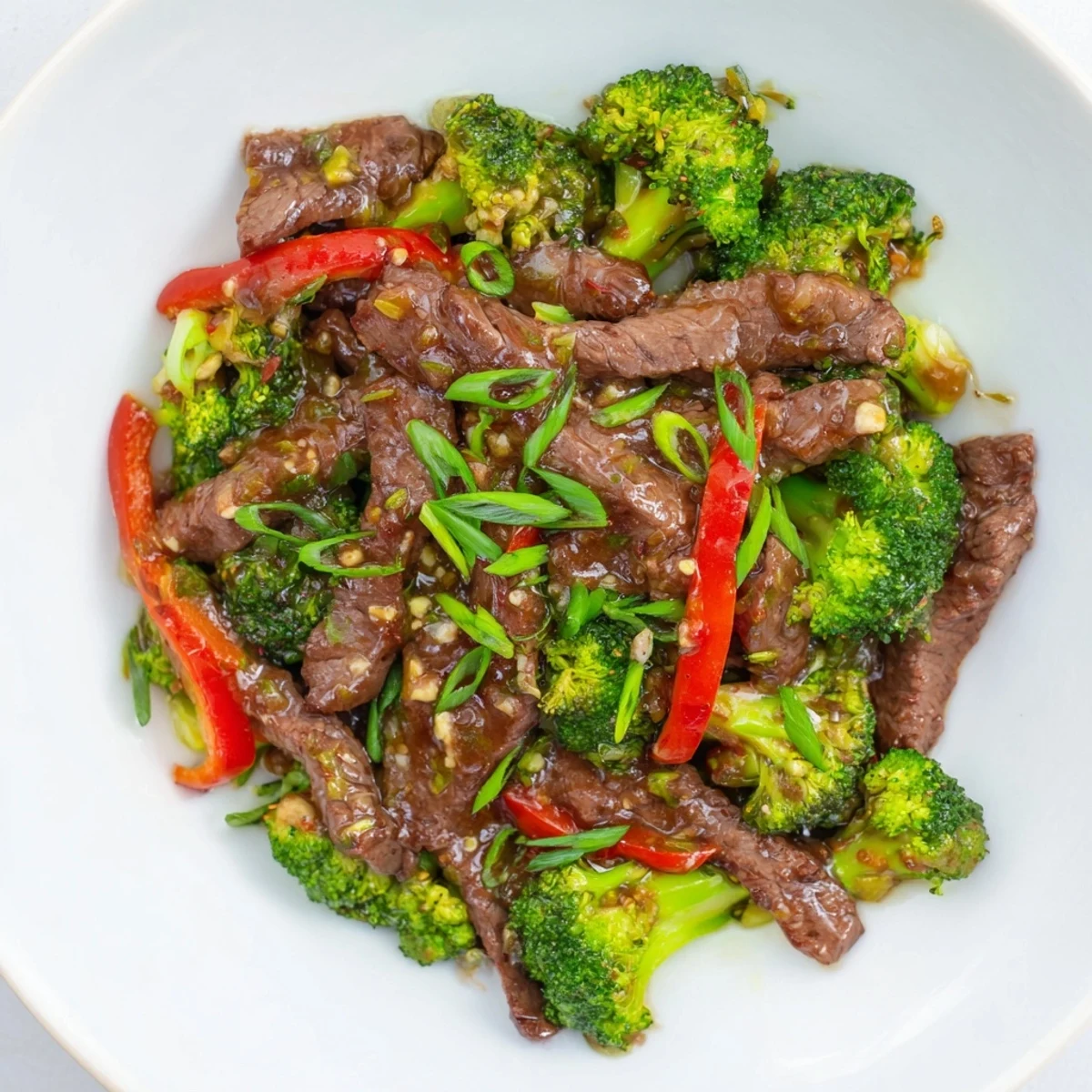 Tender beef and crisp broccoli florets glisten with savory garlic soy sauce in this classic Beef and Broccoli Stir Fry.