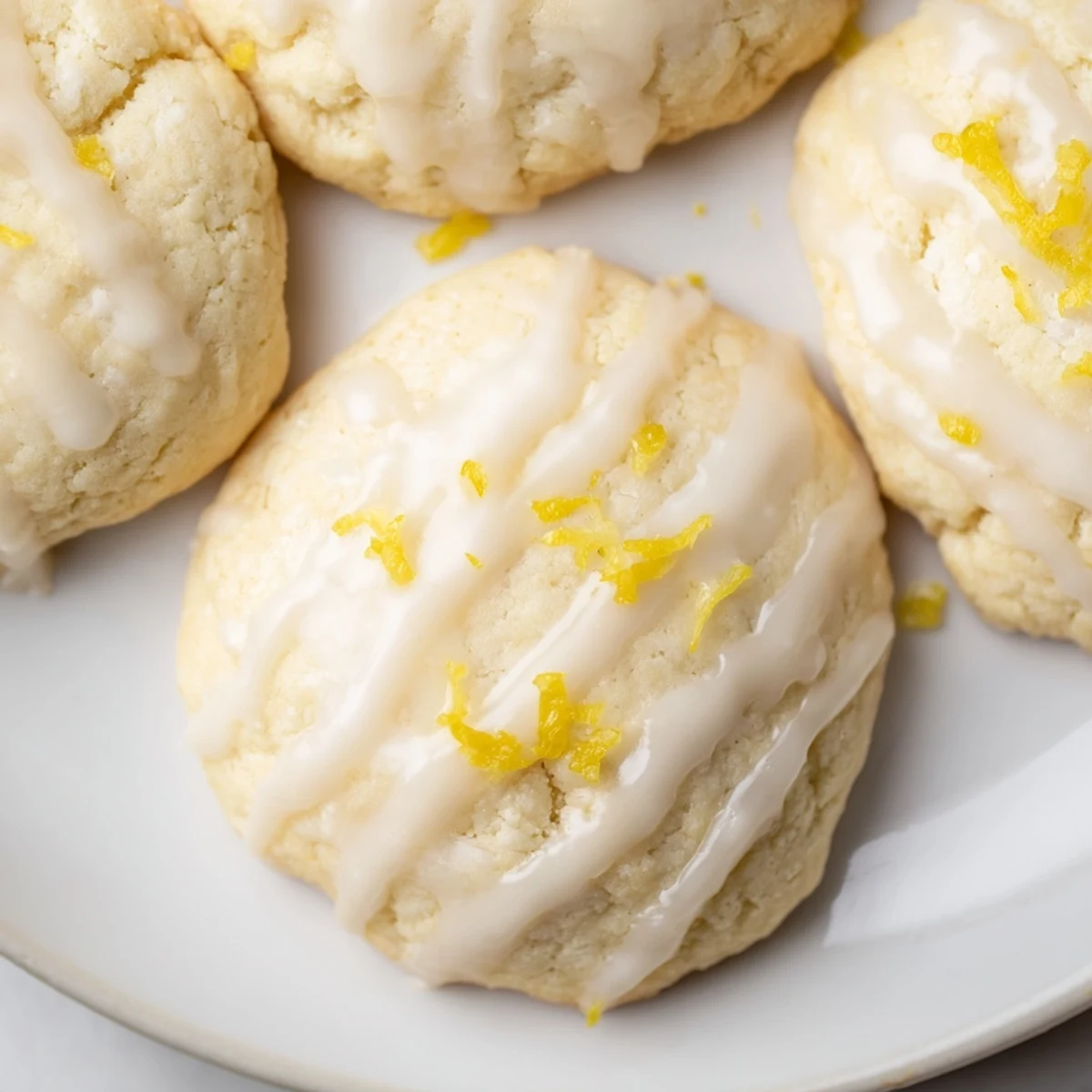 Freshly baked Lemon Ricotta Cookies with sweet lemon glaze on a cooling rack, radiating a soft, pillowy texture and vibrant citrus aroma.