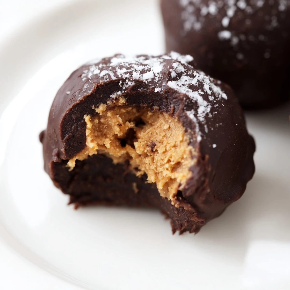 Platter of homemade Chocolate Peanut Butter Balls with a creamy peanut butter filling, ready to be shared at any holiday party.