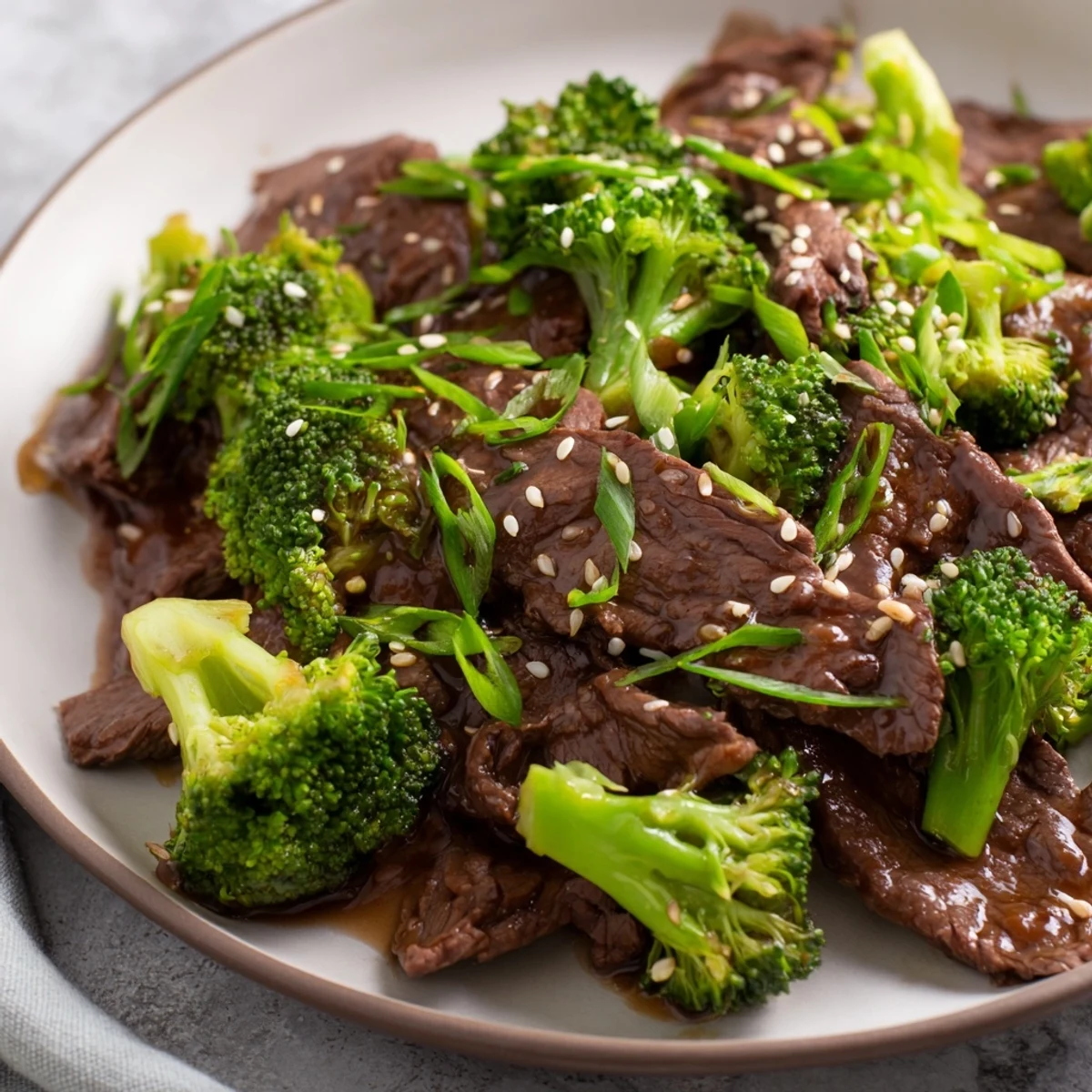 Hot stir-fry in a wok, steam rising from a colorful beef and broccoli dish with a rich ginger glaze.