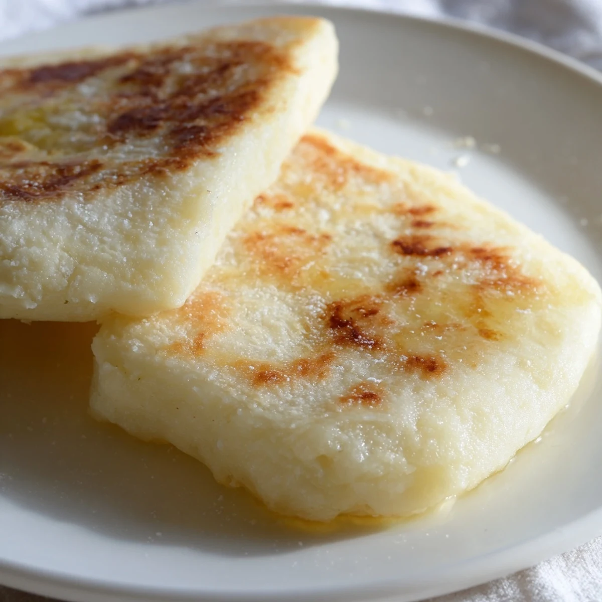Soft, warm Irish Potato Bread Farls with a crispy edge, ready to be slathered with jam.