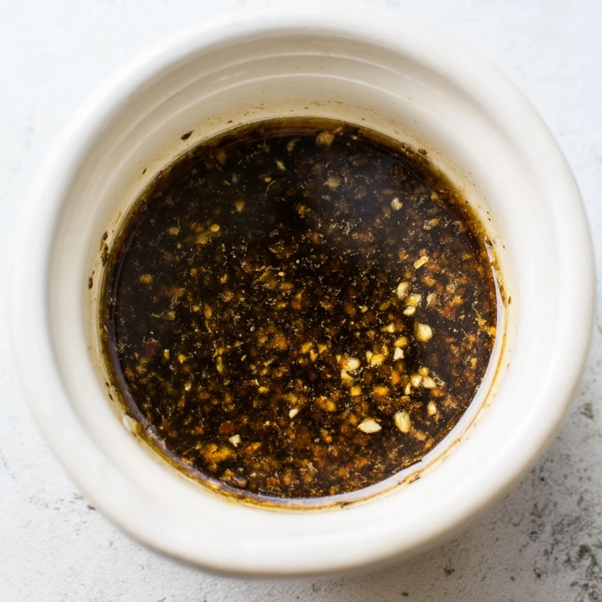 This Best Asian Coleslaw Dressing is drizzled over crunchy vegetables, topped with sesame seeds and fresh cilantro leaves.