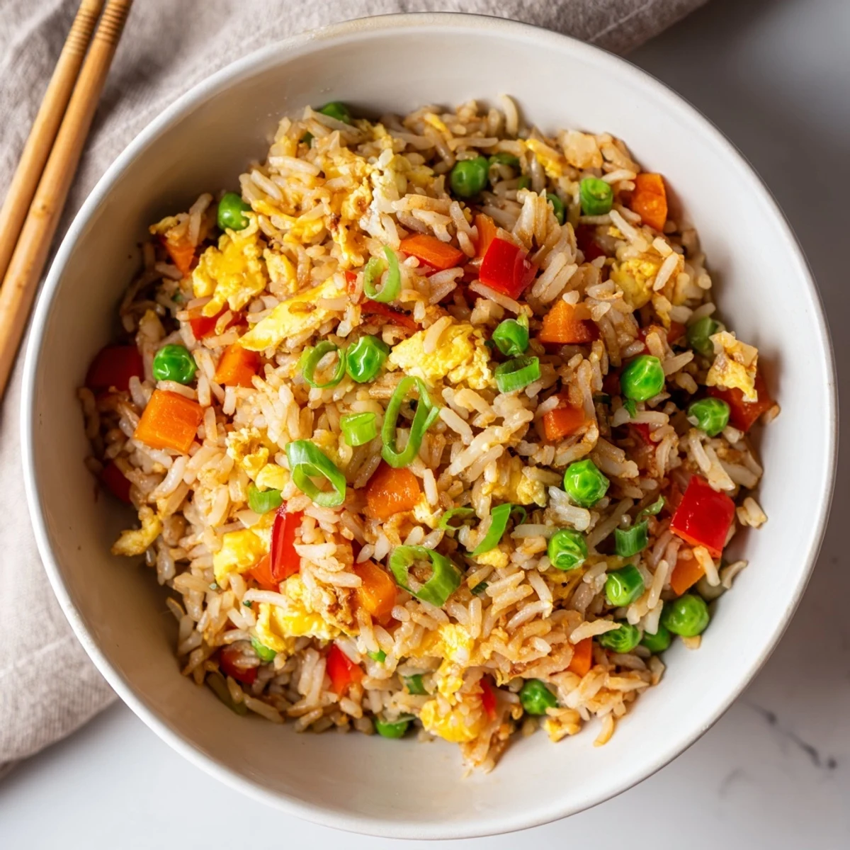 Fried Rice shows scrambled eggs and green onions tossed in a wok with savory soy sauce.
