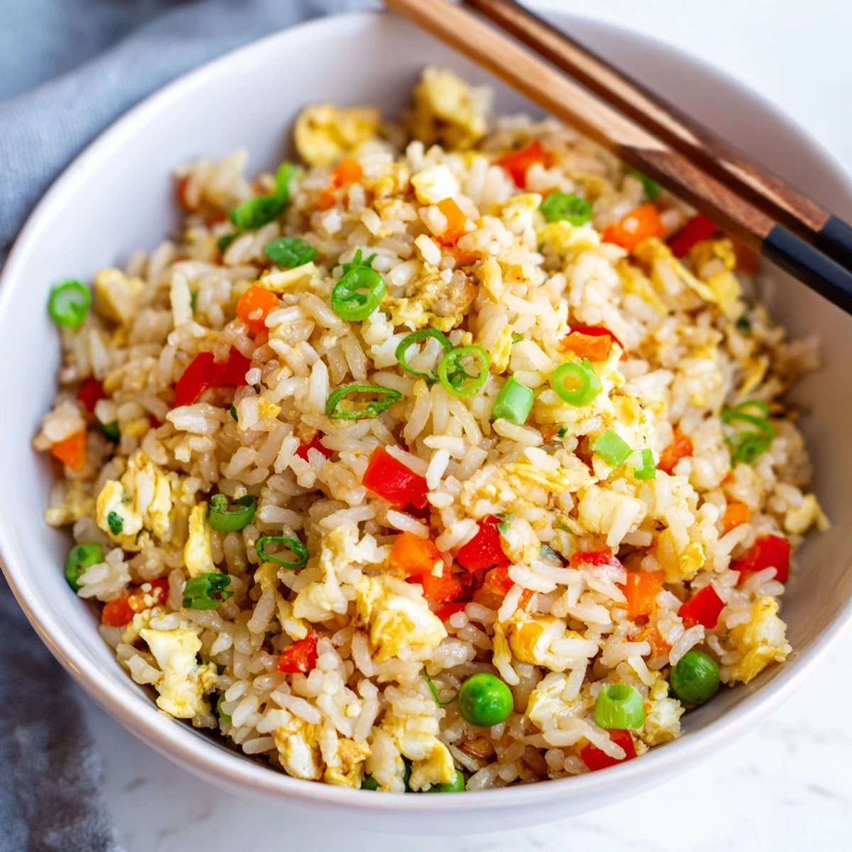 Serving suggestion for Fried Rice with diced bell peppers and peas, ready to enjoy.