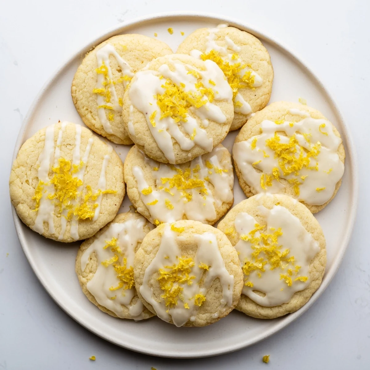 Glistening Limoncello Cookies arranged on a wire rack with a sweet lemon glaze dripping over golden edges, perfect for summer gatherings.