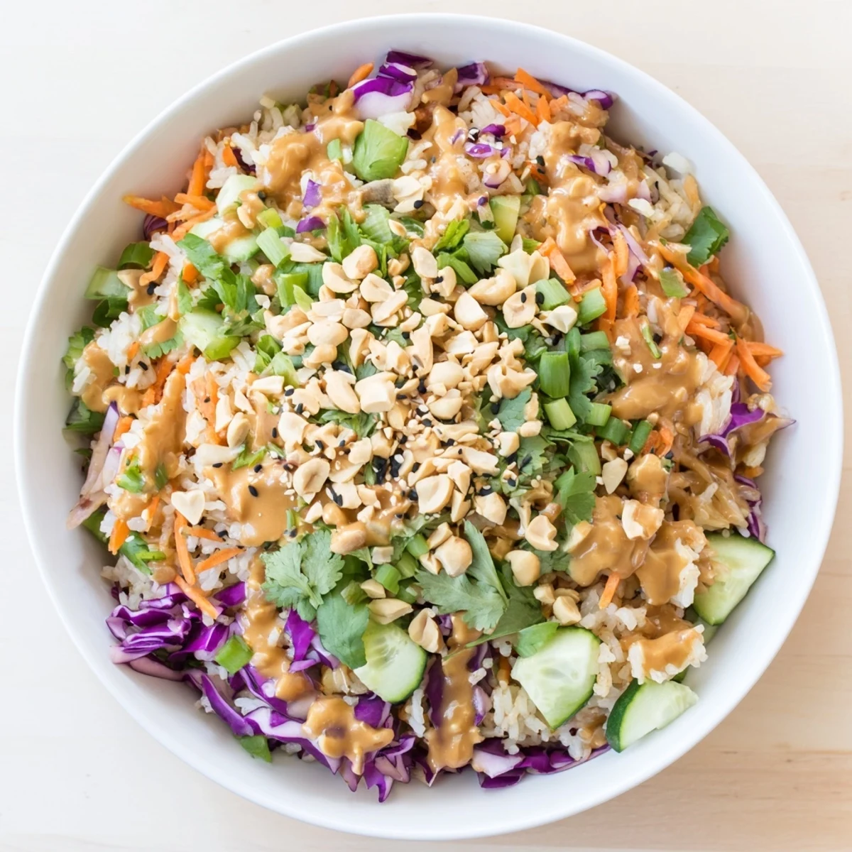 Golden fried rice cubes mixed with shredded purple cabbage and crunchy peanuts in Asian-inspired salad
