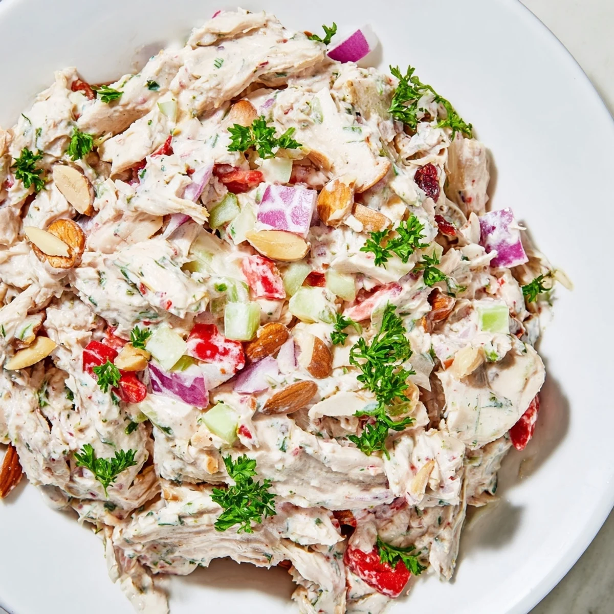 Healthy Greek yogurt rotisserie chicken salad plated with crunchy celery and vibrant diced vegetables