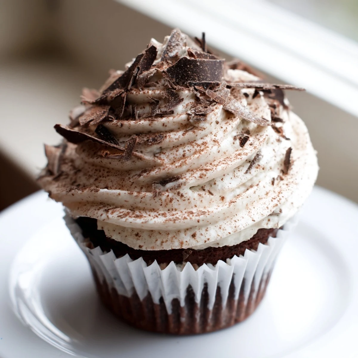 Decadent chocolate tiramisu cupcakes topped with fluffy mascarpone frosting and dusted cocoa powder