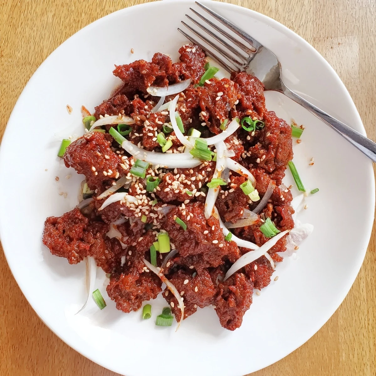 Golden tender Slow Cooker Korean Beef pieces coated in rich glossy brown garlic sauce