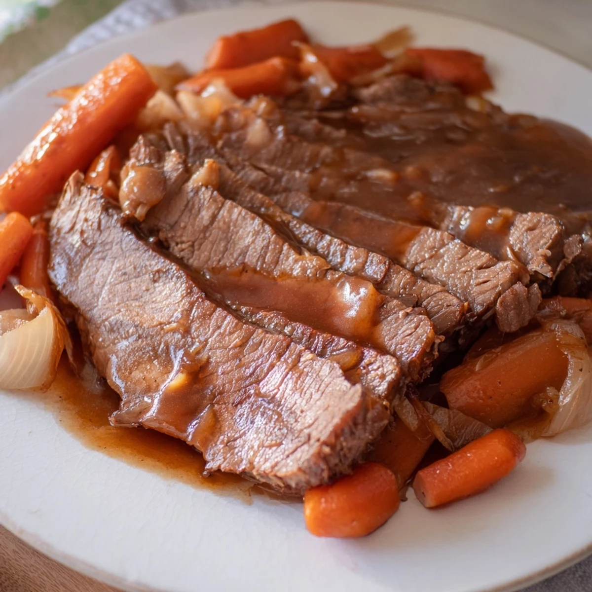 Savory slow cooker beef brisket served family-style with spooned over dark barbecue gravy and seasonal vegetables
