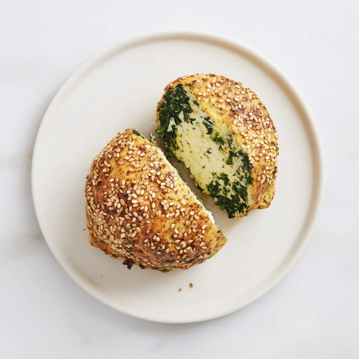 Warm spinach cottage cheese flagels with green specks visible in the creamy white cheese filling