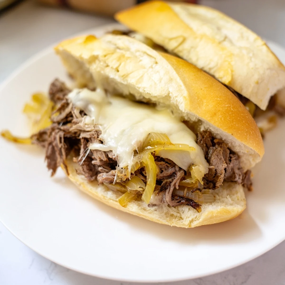 Savory slow-cooked Crockpot French Dip Sandwiches with juicy shredded beef and melted cheese on a fresh baked roll