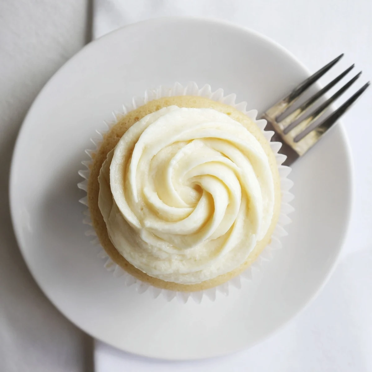 Batch of homemade vanilla cupcakes with swirl frosting ready for birthday celebrations