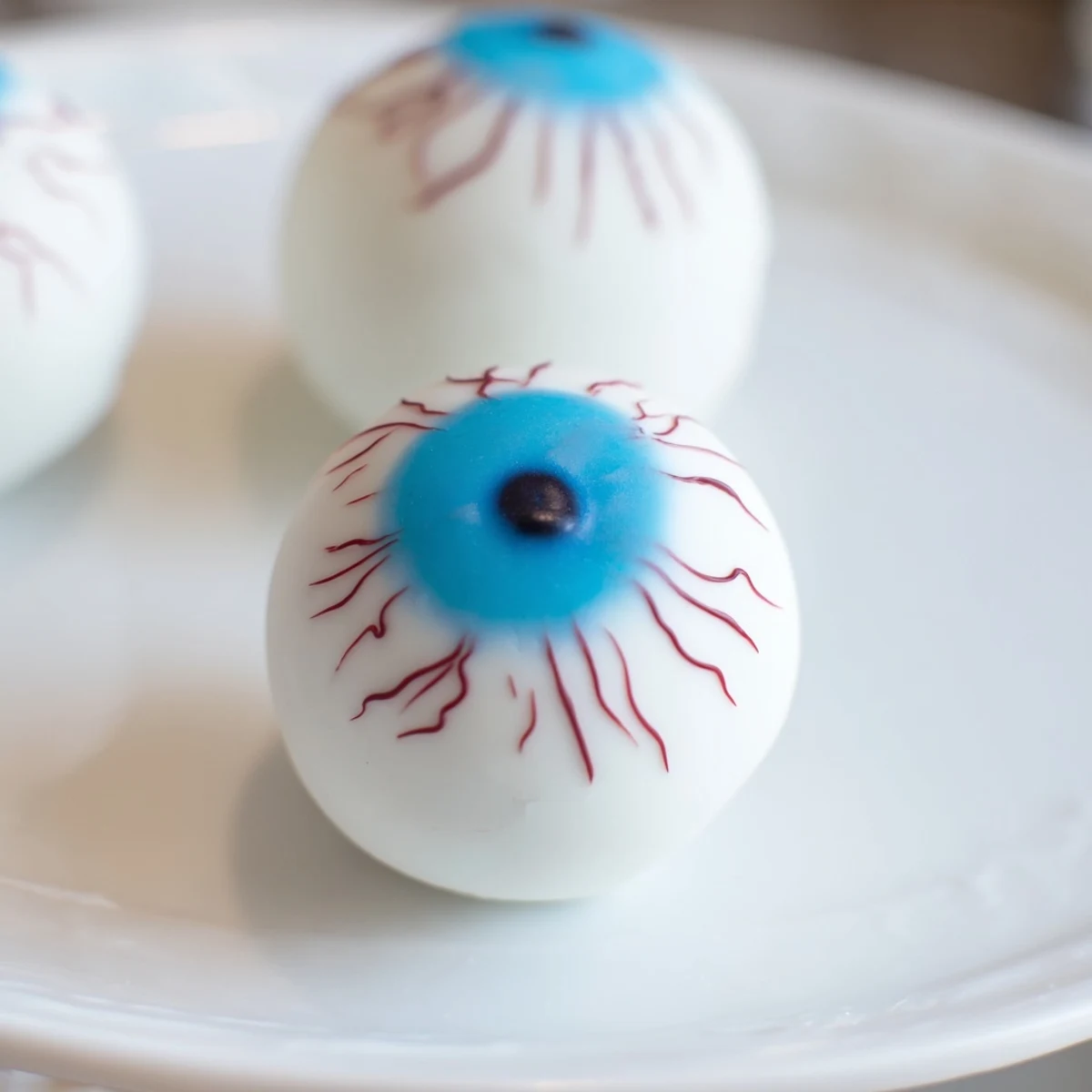 Creepy Halloween Cake Eyeballs with red veins on a spooky party platter