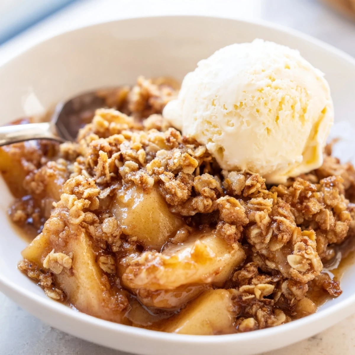 Warm crockpot apple crisp with tender cinnamon apples and golden oat topping in a slow cooker