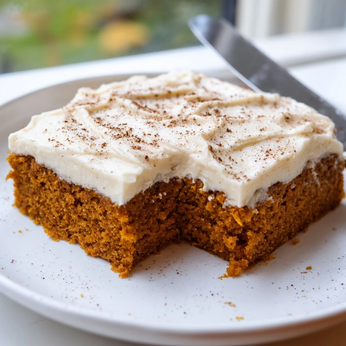 Creamy frosted pumpkin bars with warm spices cut into generous fall dessert squares