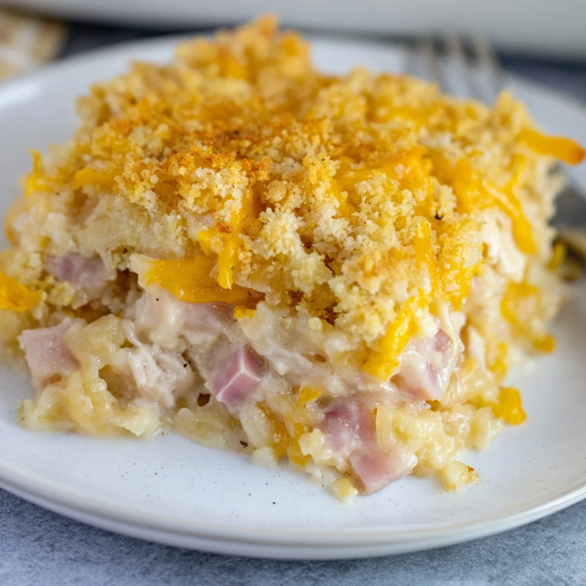 Hearty Chicken Cordon Bleu Casserole Recipe sliced, showing tender chicken and gooey Swiss