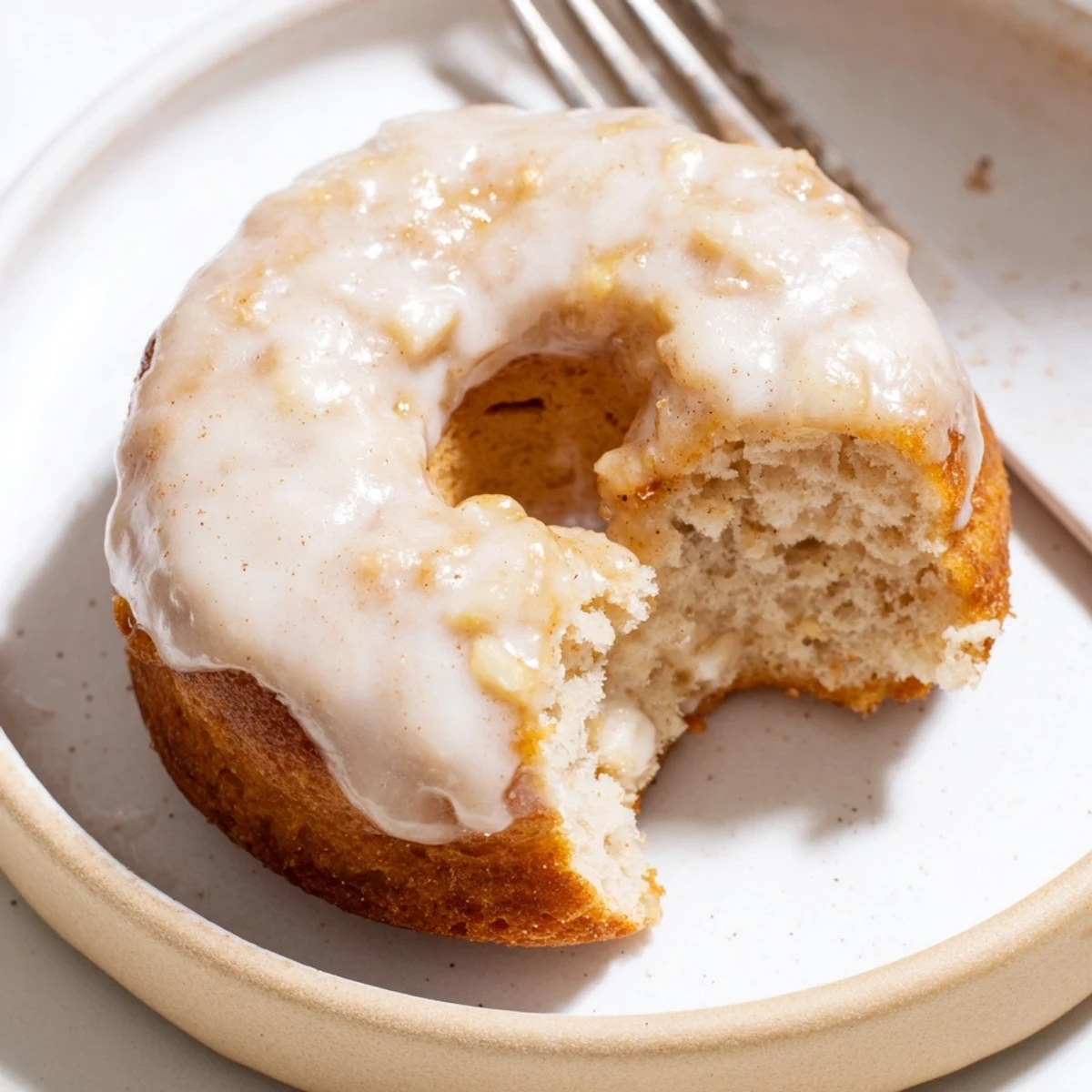 Plate of fluffy Banana Donuts sliced to reveal soft, cake-like interior