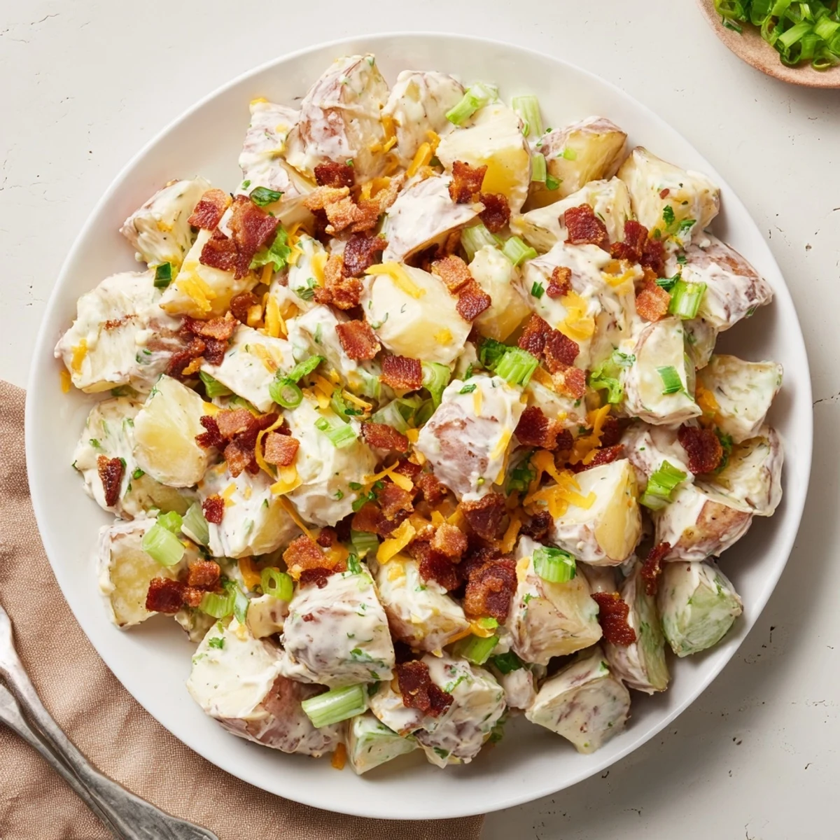 Beef Bacon Loaded Potato Salad Recipe For A Crowd Delight, creamy, smoky, garnished.