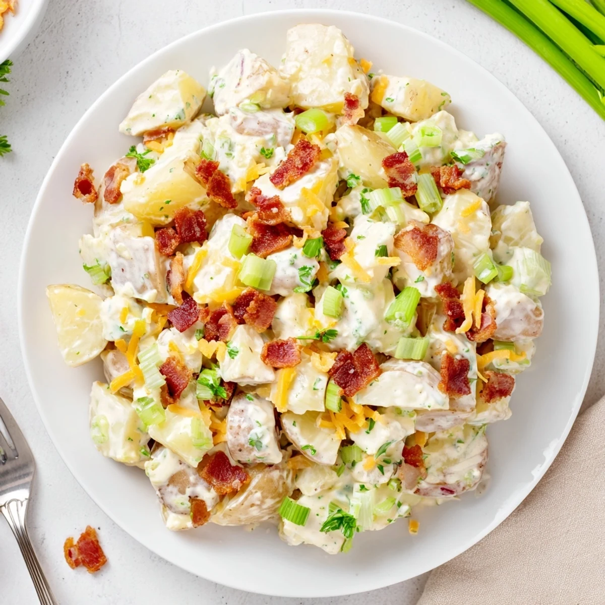 Warm, chunky servings highlight Beef Bacon Loaded Potato Salad Recipe For A Crowd Delight.