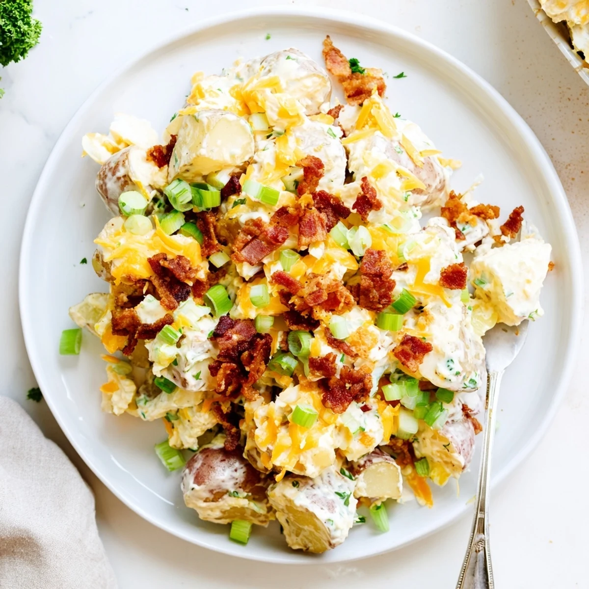 Hearty potluck scoop of Beef Bacon Loaded Potato Salad Recipe For A Crowd Delight.