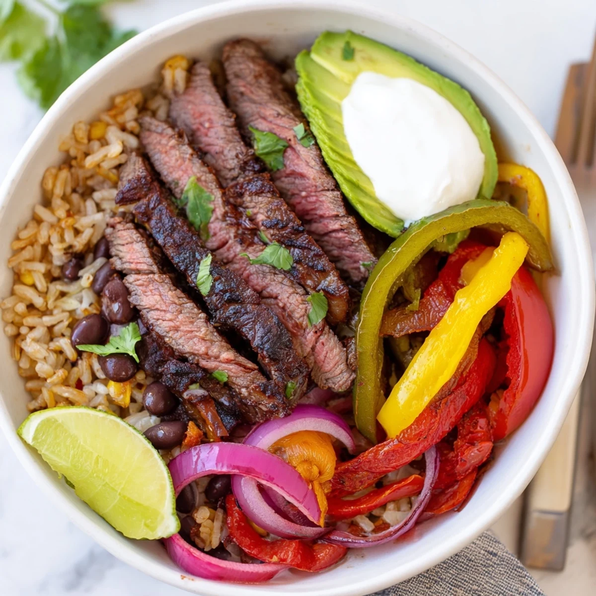 Steak Fajita Power Bowls served warm with lime wedges and tangy yogurt