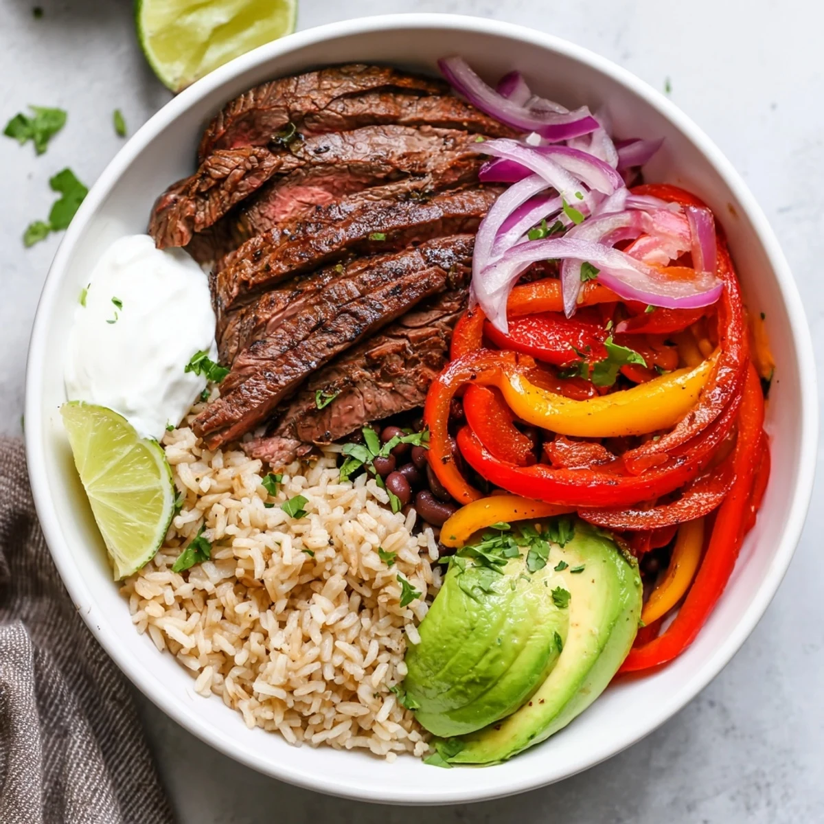 Hearty layers of brown rice, black beans, and steak in Steak Fajita Power Bowls