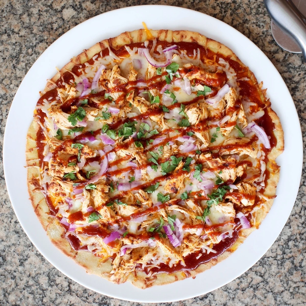 Savory BBQ chicken pizza featuring smoky grilled chicken slices, bubbly mozzarella and gouda cheese toppings