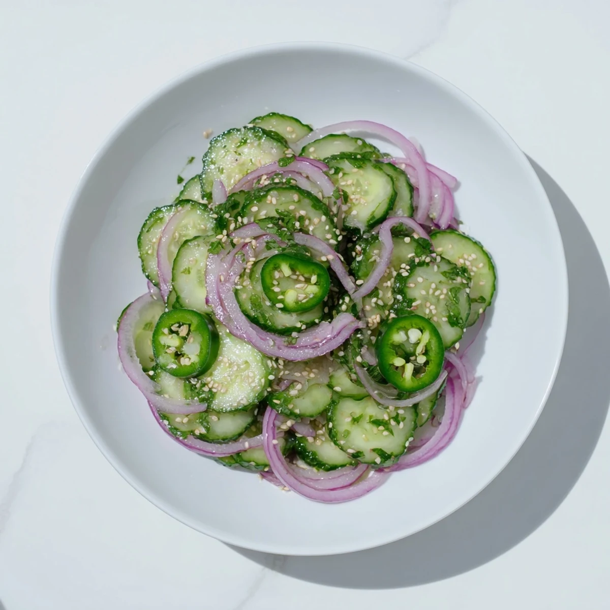 Refreshing honey lime cucumber salad featuring thinly sliced cucumbers coated in sweet citrus dressing
