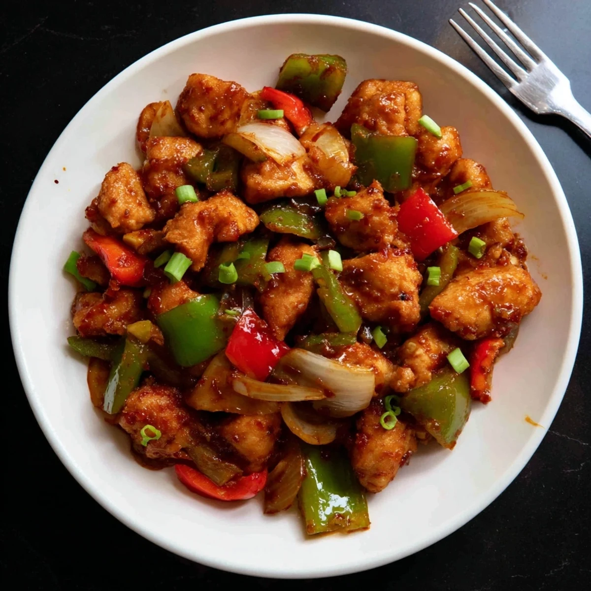 Tender, saucy bites of Flavorful Chilli Chicken Indo Chinese served over jasmine rice