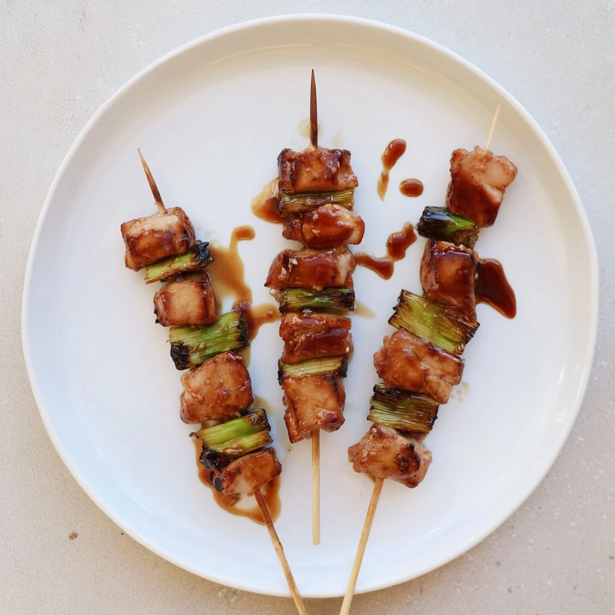 Japanese Chicken Yakitori Recipe: glossy skewers sizzling on the grill, savory-sweet aroma
