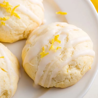 A platter of Lemon Ricotta Cookies drizzled with tangy sweet glaze, perfect for spring brunch or afternoon tea with friends.