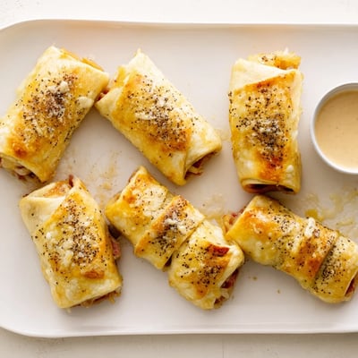 These Keto Crispy Reuben Roll Ups feature corned beef and sauerkraut, baked until golden with melted Swiss cheese.  